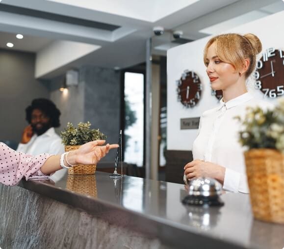 Blonde-woman-hotel-guest-checking-in-at-front-desk
