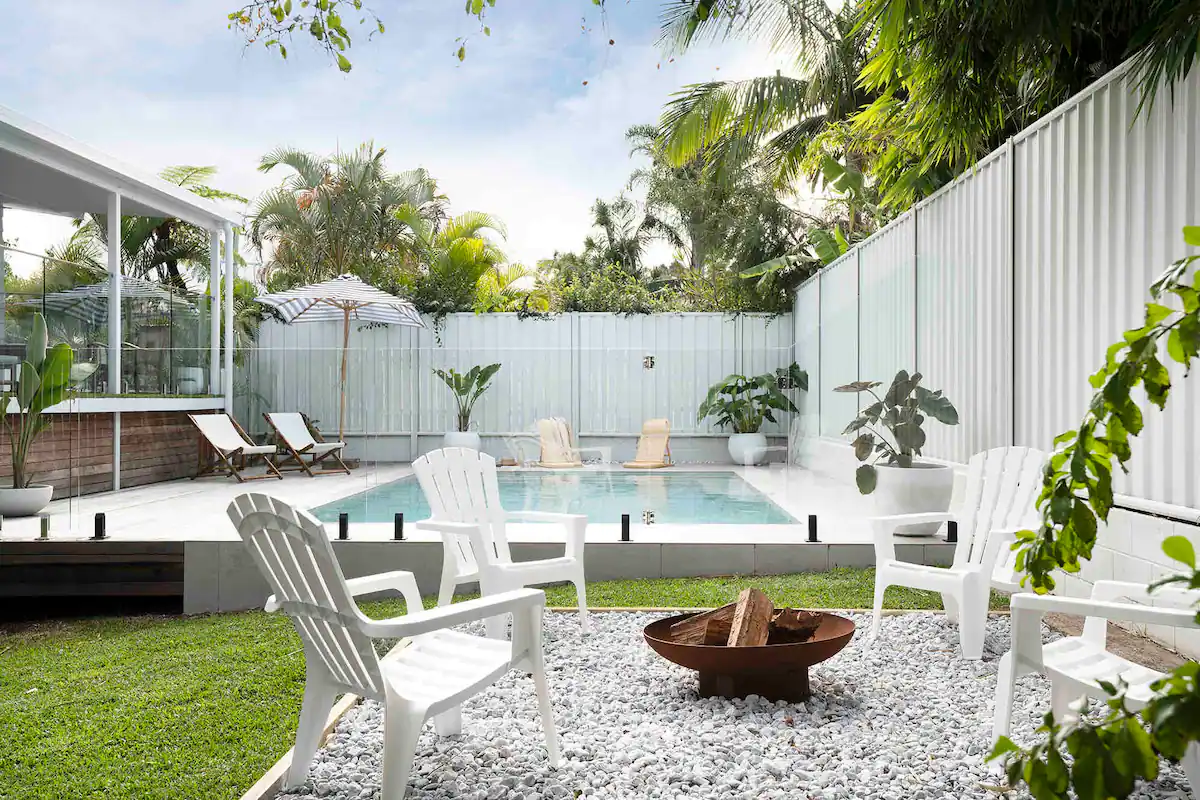 Airbnb Mooloolaba Property Managers with a white exterior for a pool sitting in a nice sunny day