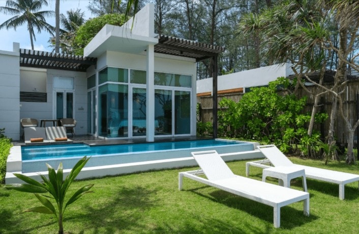 gorgeous backyard with a sleek and stylist pool infront of a an amazing spread for grow host