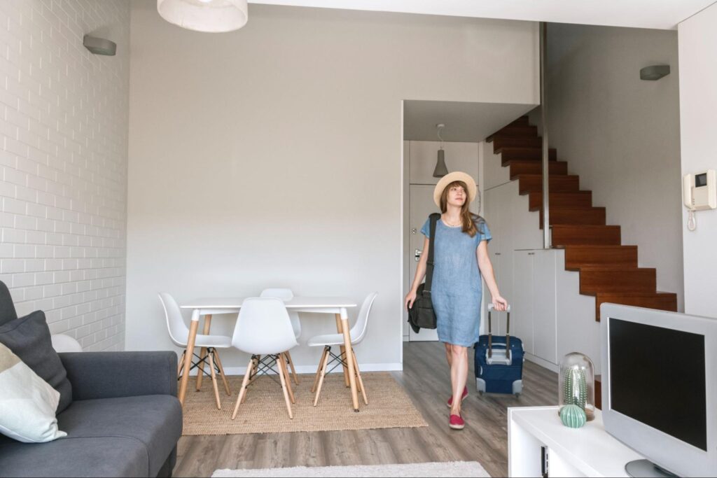 Woman walking into a home holiday rental